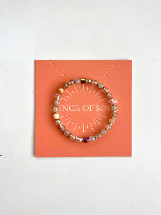 Pebble stone beaded bracelet on a 'ounce of Soul' branded card with a white background