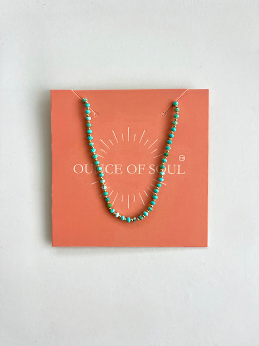 Turquoise beaded necklace on a 'ounce of Soul' branded card against a white background